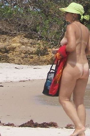 A busty bikini slut undressing on the Coralita