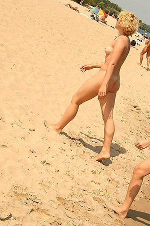 A busty bikini bitch undressing on the Natadola