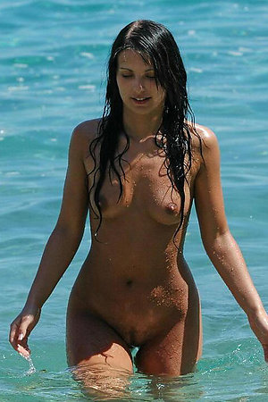 A busty bikini babe undressing on the Hanauma