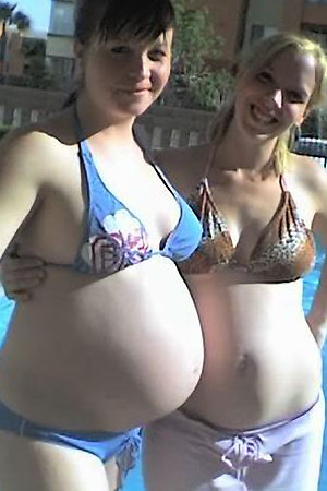 Nudist pregnant girls having fun in a pool
